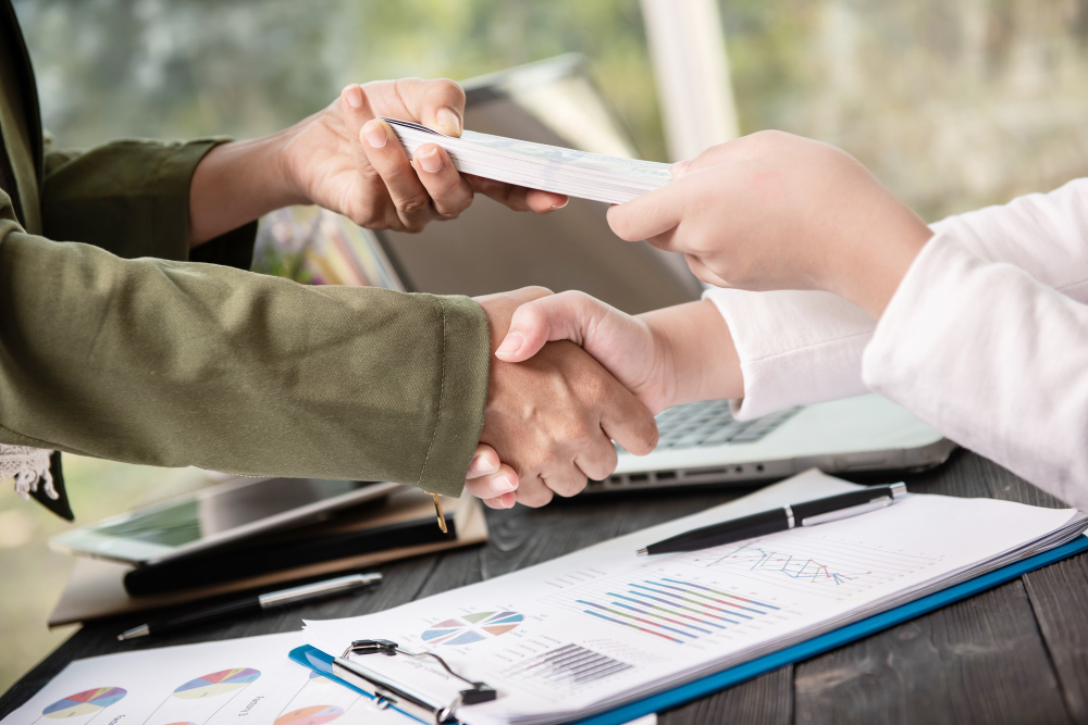 Image of a loan officer and borrower shaking hands after installment loans approval